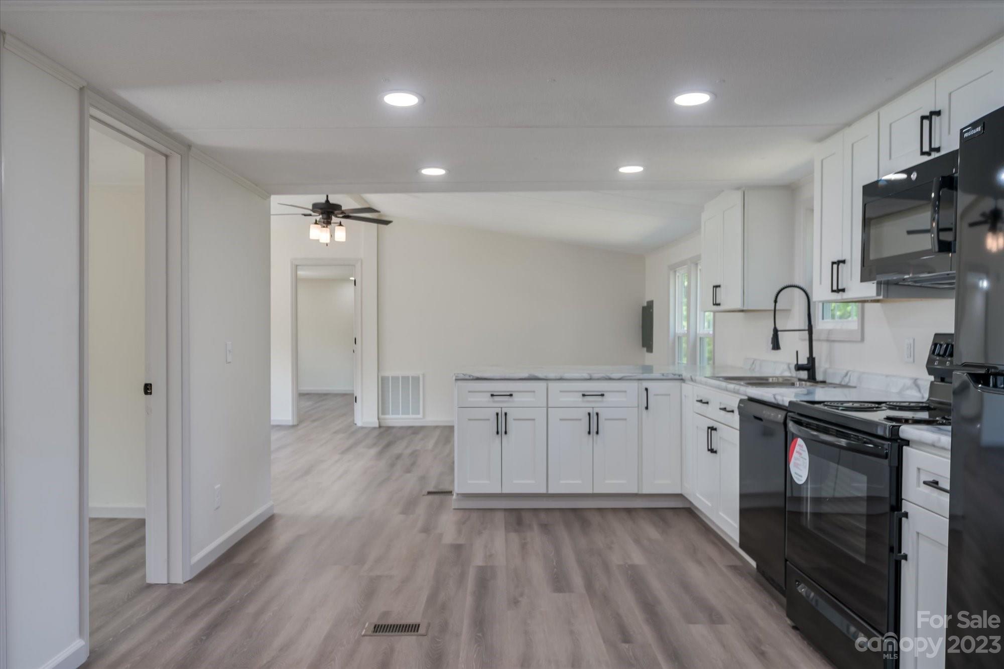 175 King Stepp Road Mill Spring, NC 28756 - Photo 9 of 46 a kitchen with appliances a sink and cabinets