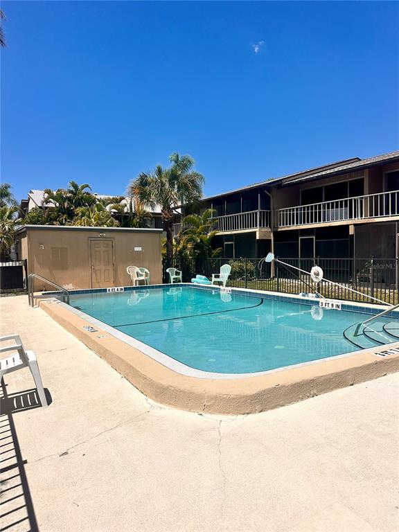 2938 Clark Road, Unit 203 Sarasota, FL 34231 - Photo 13 of 13 a view of a swimming pool with a house in the background