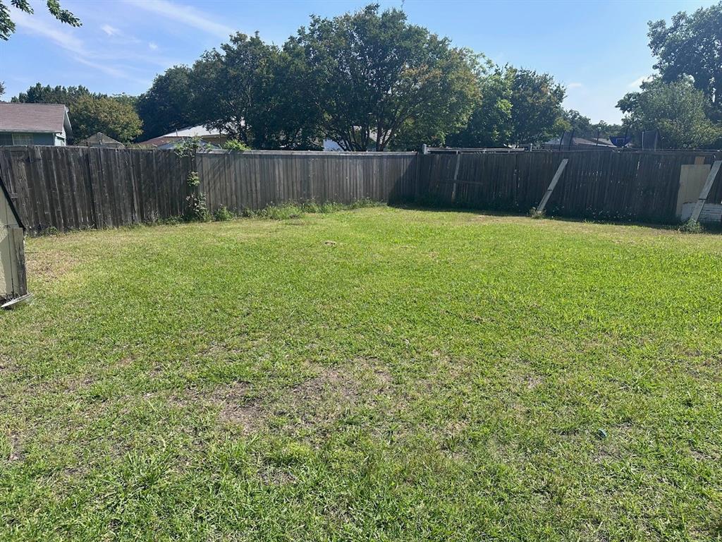 2103 Carlton Road Carrollton, TX 75007 - Photo 14 of 18 a view of a backyard with a small cabin