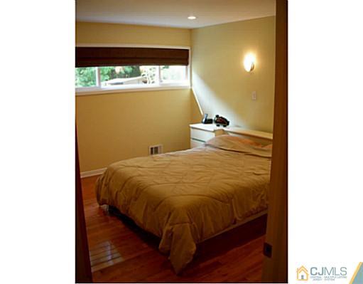 192 Princeton Road Old Bridge, NJ 08859 - Photo 13 of 25 a bed sitting in a room next to a window