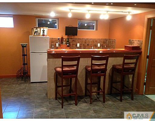 192 Princeton Road Old Bridge, NJ 08859 - Photo 17 of 25 a kitchen with a sink cabinets and dining table