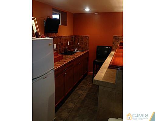 192 Princeton Road Old Bridge, NJ 08859 - Photo 18 of 25 a kitchen with stainless steel appliances kitchen island sink stove and refrigerator