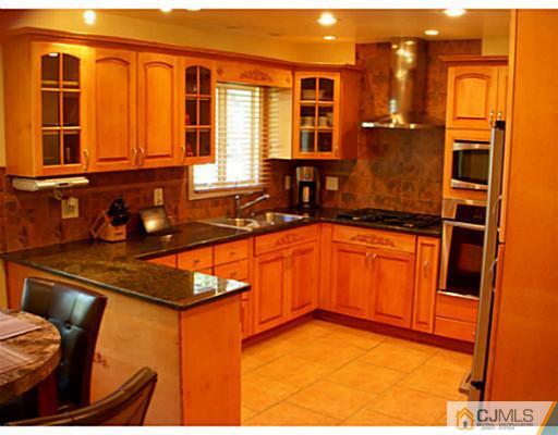 192 Princeton Road Old Bridge, NJ 08859 - Photo 5 of 25 a kitchen with a sink and a refrigerator