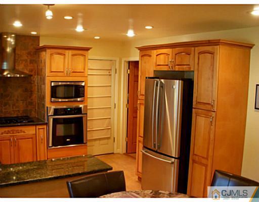 192 Princeton Road Old Bridge, NJ 08859 - Photo 6 of 25 a kitchen with stainless steel appliances granite countertop a refrigerator and a stove top oven