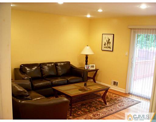 192 Princeton Road Old Bridge, NJ 08859 - Photo 9 of 25 a living room with a couch and a table