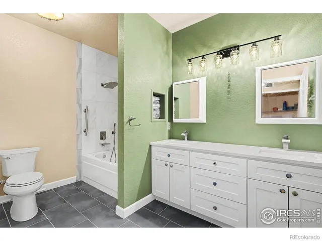 a bathroom with a toilet sink and a mirror