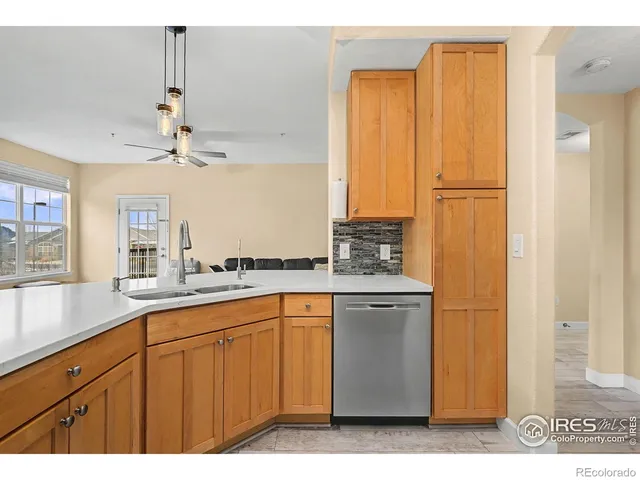 a kitchen with kitchen island granite countertop appliances cabinets and a counter top space
