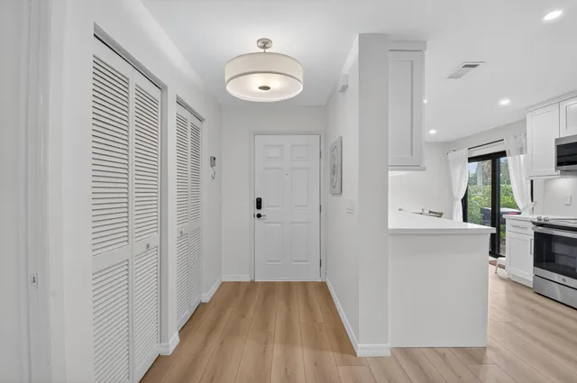 a kitchen with stainless steel appliances kitchen island granite countertop a table and chairs