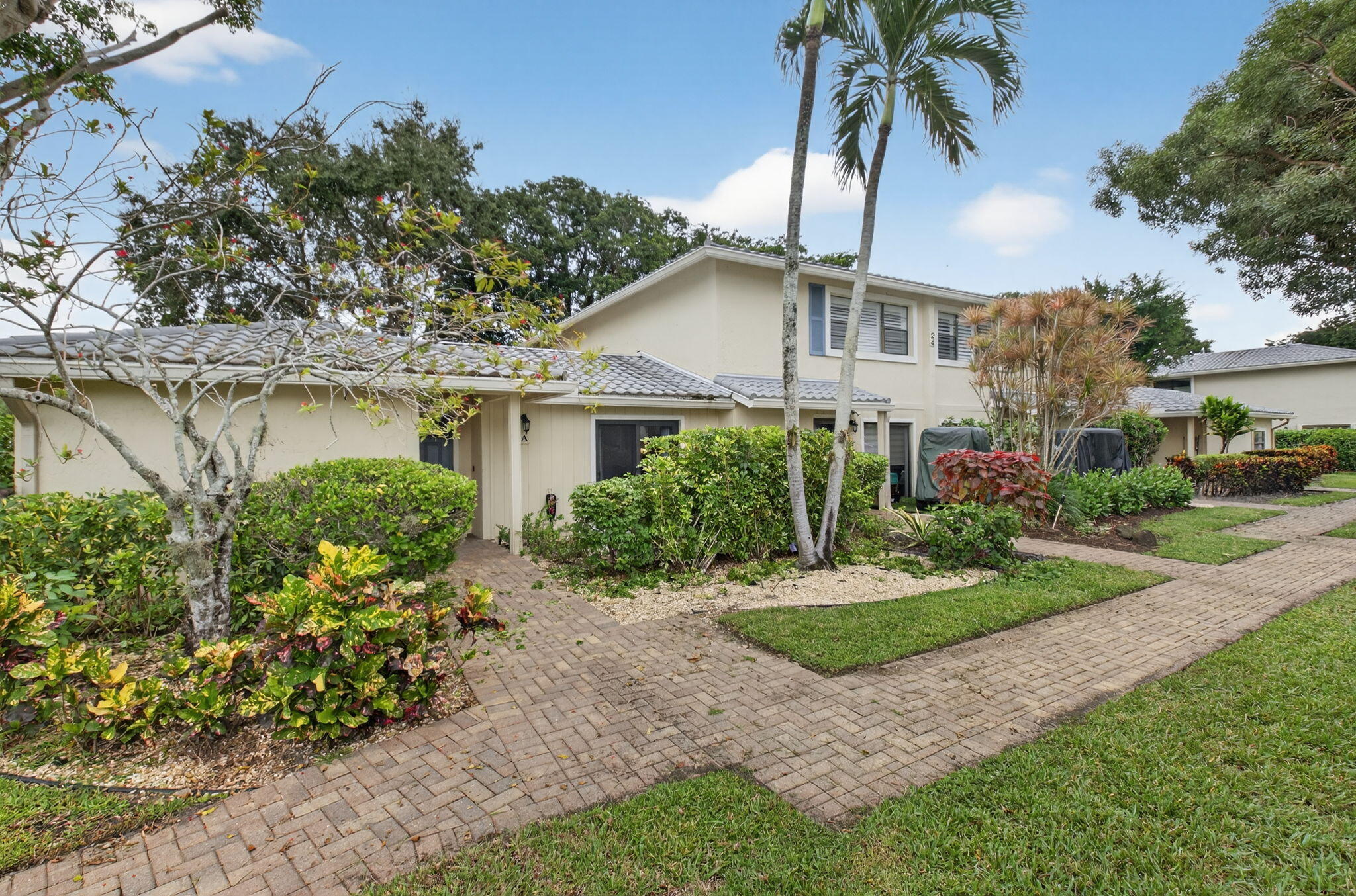24 Westgate Lane, Unit A Boynton Beach, FL 33436 - Photo 17 of 94 a front view of a house with a garden