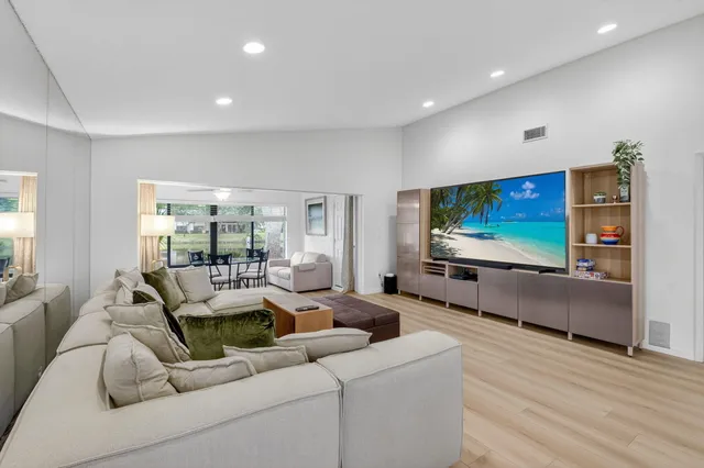 an aerial view of a house with a yard and lake view