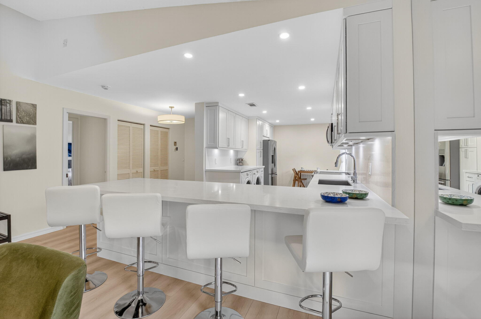 24 Westgate Lane, Unit A Boynton Beach, FL 33436 - Photo 3 of 94 a kitchen with stainless steel appliances kitchen island granite countertop a table and chairs