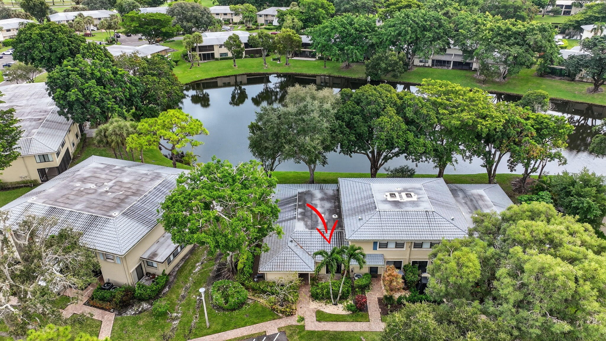 24 Westgate Lane, Unit A Boynton Beach, FL 33436 - Photo 41 of 94 an aerial view of a house with a garden and lake view