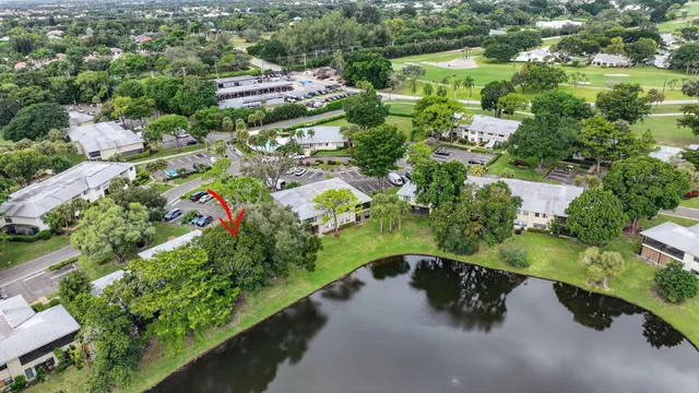 an aerial view of residential houses with outdoor space and trees