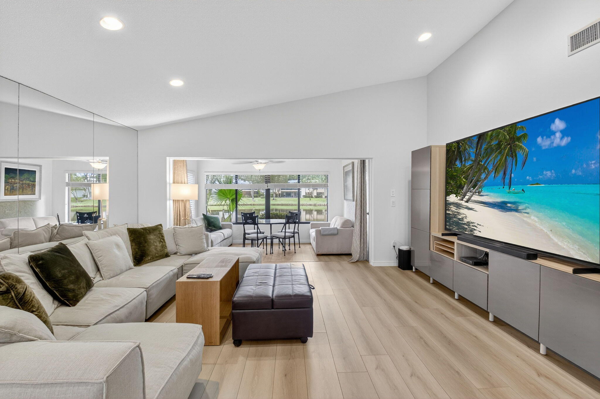 24 Westgate Lane, Unit A Boynton Beach, FL 33436 - Photo 8 of 94 a living room with furniture flat screen tv and large window