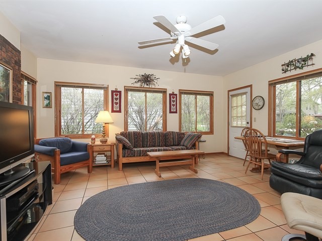 27 Green Ridge Road Elgin, IL 60120 - Photo 11 of 21 a living room with furniture a large window and a flat screen tv