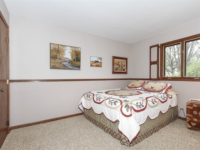 27 Green Ridge Road Elgin, IL 60120 - Photo 15 of 21 a bedroom with a bed and a table in it