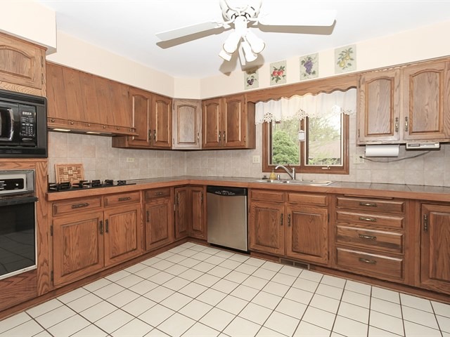 27 Green Ridge Road Elgin, IL 60120 - Photo 7 of 21 a kitchen with stainless steel appliances granite countertop a sink and cabinets