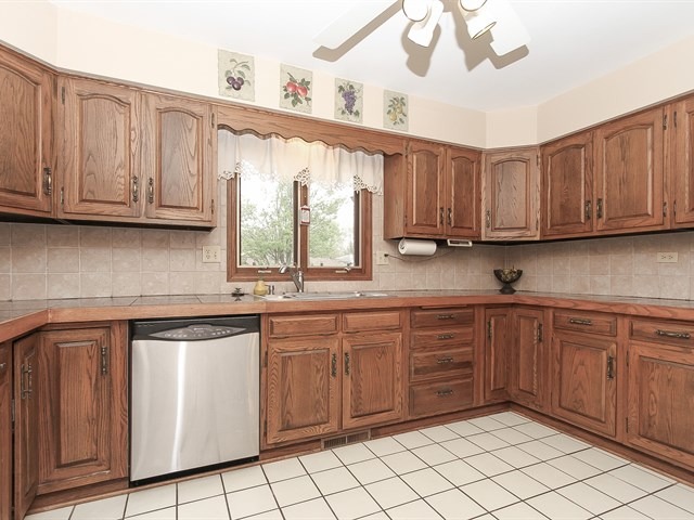 27 Green Ridge Road Elgin, IL 60120 - Photo 9 of 21 a kitchen with stainless steel appliances granite countertop a sink and cabinets