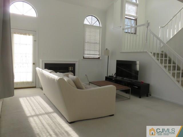 5006 Stonehedge Road Edison, NJ 08820 - Photo 3 of 14 a living room with furniture and a flat screen tv