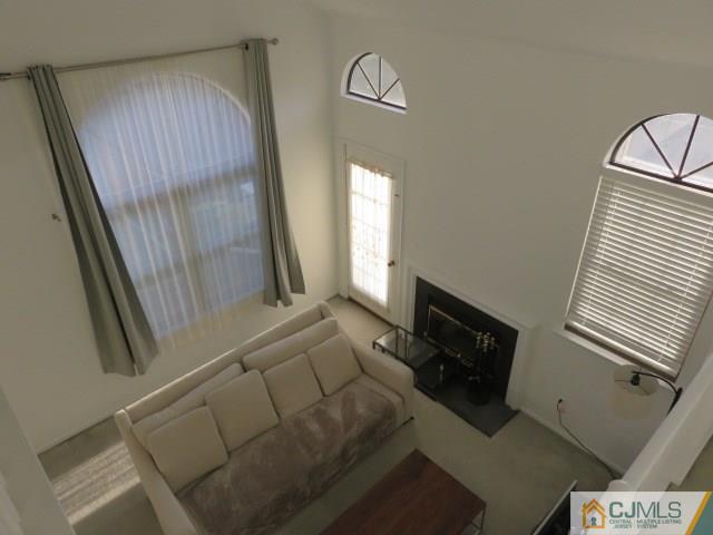 5006 Stonehedge Road Edison, NJ 08820 - Photo 6 of 14 a living room with furniture and a fireplace