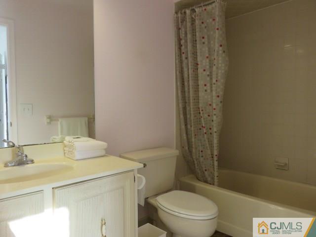 5006 Stonehedge Road Edison, NJ 08820 - Photo 8 of 14 a bathroom with a sink a toilet and shower