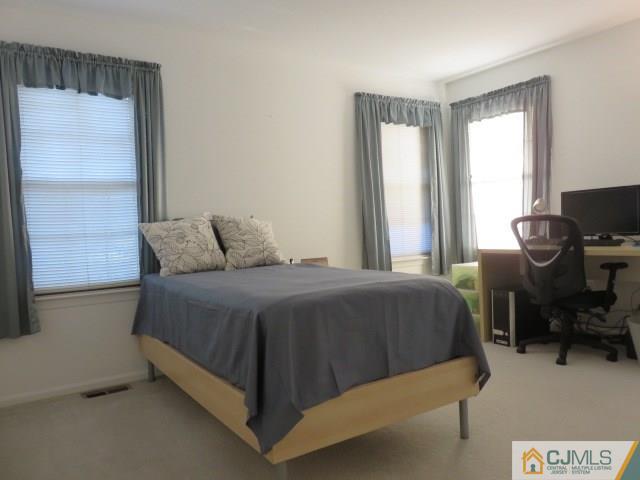 5006 Stonehedge Road Edison, NJ 08820 - Photo 9 of 14 a bedroom with a bed and a window