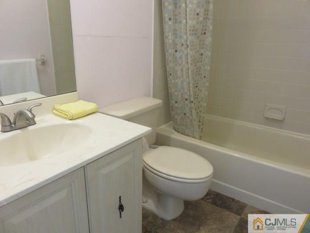 5006 Stonehedge Road Edison, NJ 08820 - Photo 10 of 14 a bathroom with a sink a toilet and shower