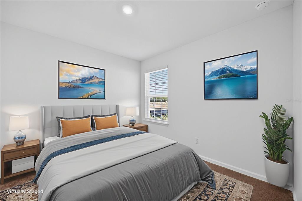 91 Tea Olive Drive Palm Coast, FL 32137 - Photo 11 of 18 a bedroom with a bed and a painting on the wall