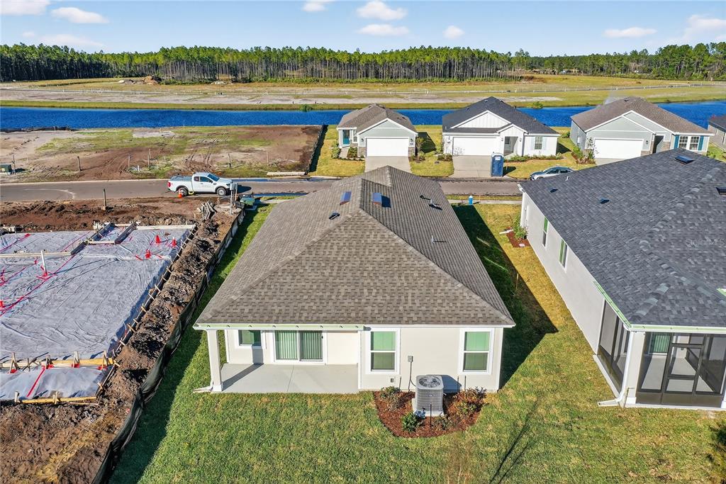 91 Tea Olive Drive Palm Coast, FL 32137 - Photo 15 of 18 an aerial view of residential houses with outdoor space and lake view
