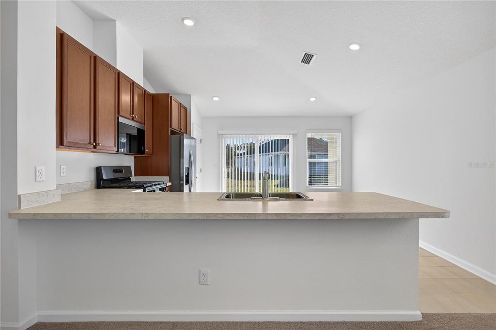 91 Tea Olive Drive Palm Coast, FL 32137 - Photo 6 of 18 a view of kitchen with stainless steel appliances granite countertop sink and cabinets