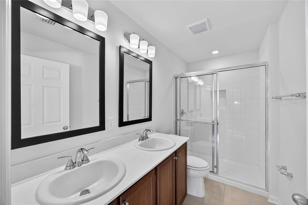 91 Tea Olive Drive Palm Coast, FL 32137 - Photo 9 of 18 a bathroom with a sink a toilet and shower