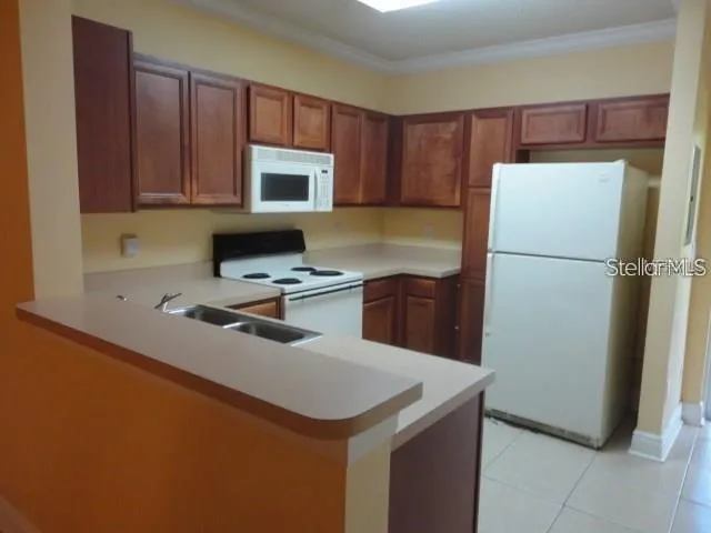 a kitchen with a refrigerator sink and cabinets