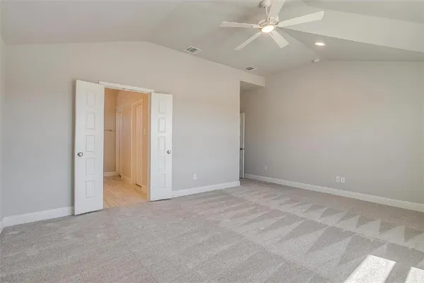an empty room with fan and ceiling fan