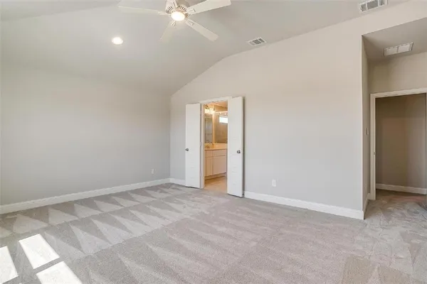 a view of an empty room with a bathroom