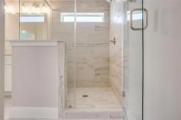 a bathroom with a glass shower door