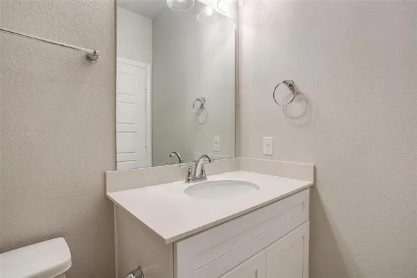 a bathroom with a sink toilet and vanity