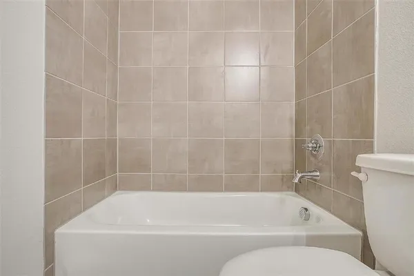 a white bath tub and a toilet