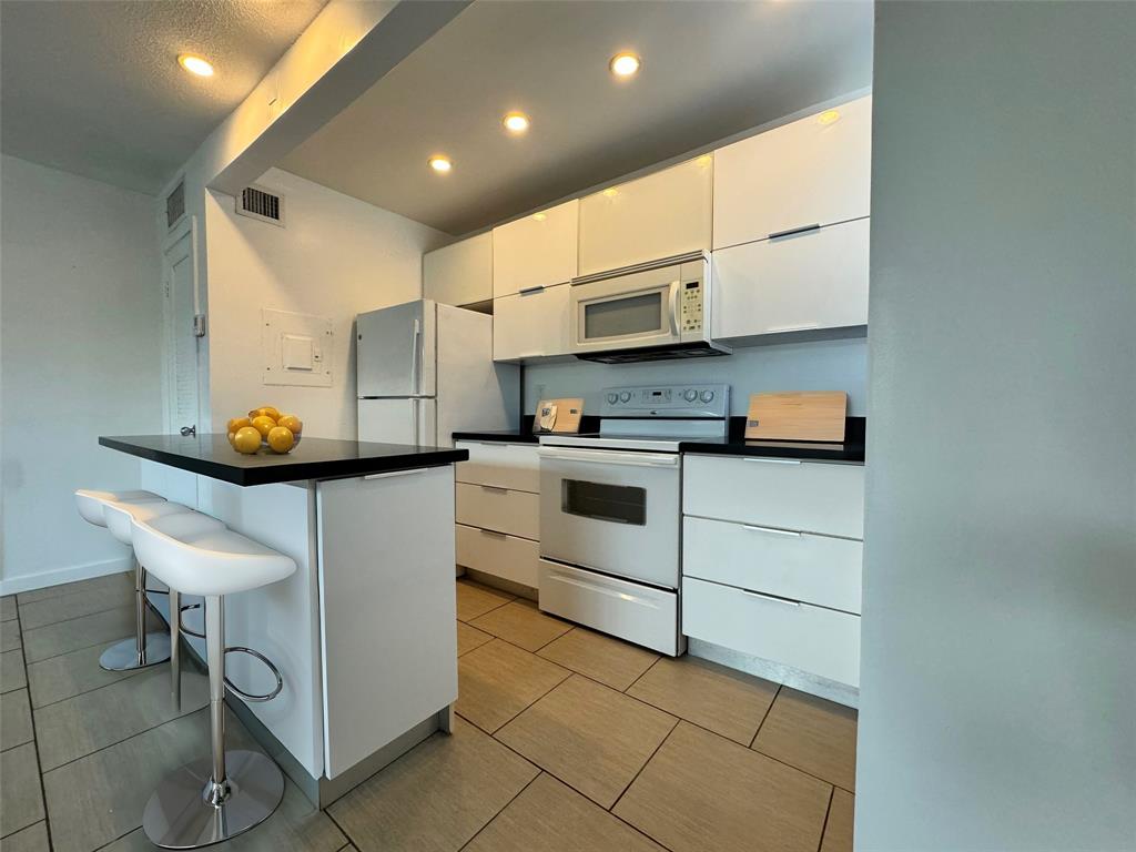 a kitchen with a sink cabinets and window