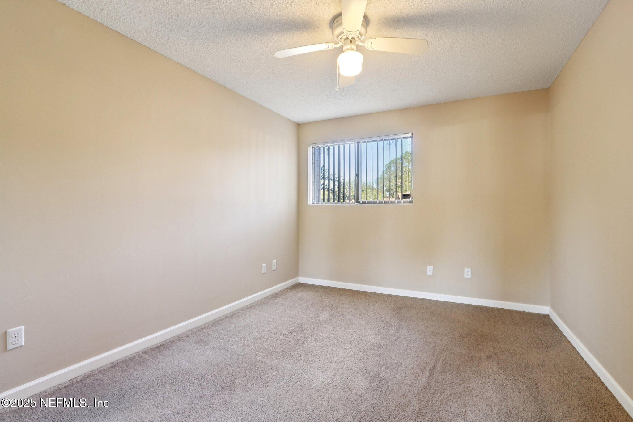 3801 Crown Point Road, Unit 2212 Jacksonville, FL 32257 - Photo 14 of 25 an empty room with windows and fan