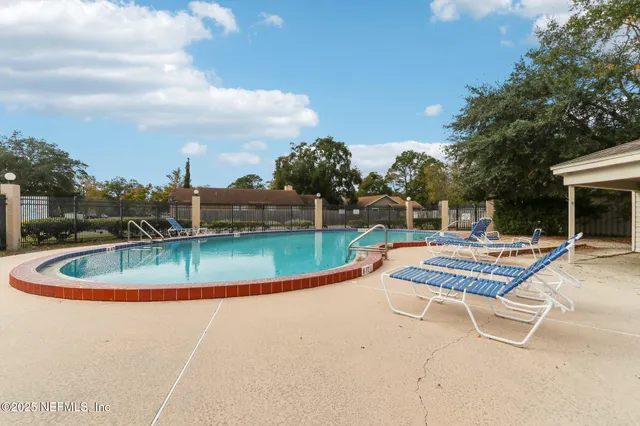 a view of a swimming pool with a outdoor seating