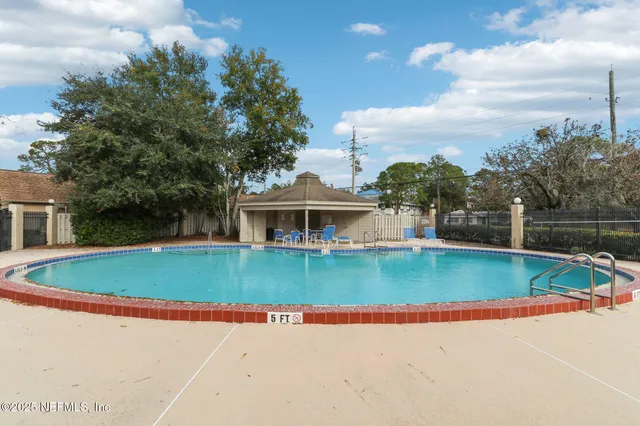 a view of a house with pool and a yard