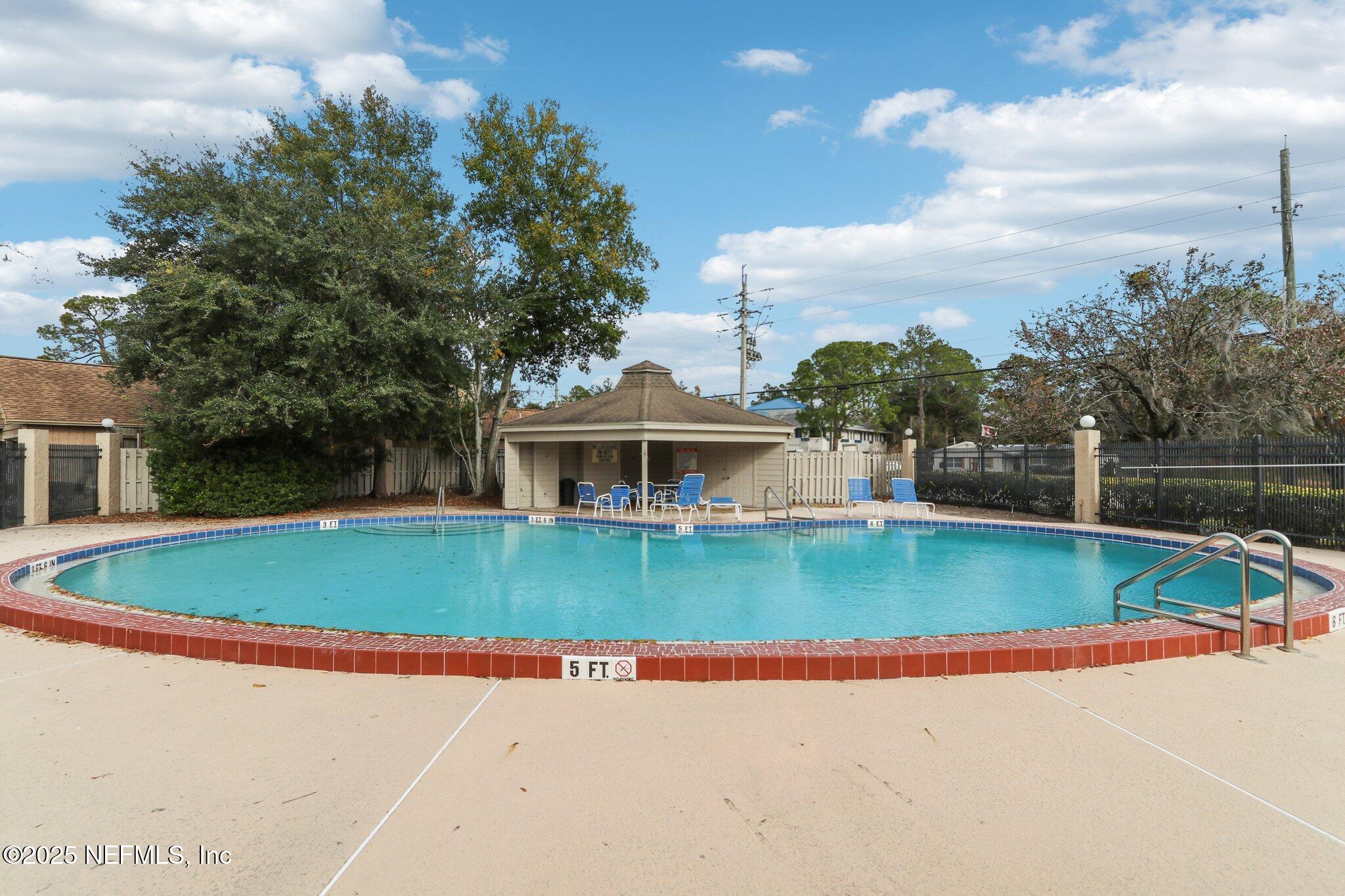 3801 Crown Point Road, Unit 2212 Jacksonville, FL 32257 - Photo 23 of 25 a view of a house with pool and a yard
