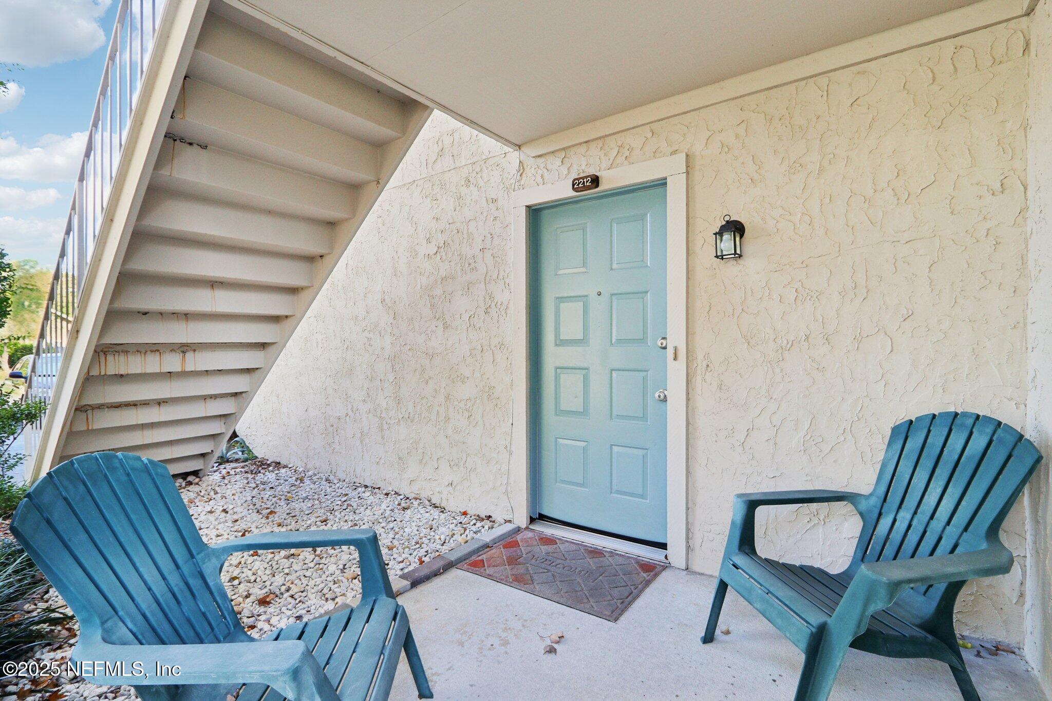 3801 Crown Point Road, Unit 2212 Jacksonville, FL 32257 - Photo 3 of 25 a view of a hallway with furniture and wooden floor
