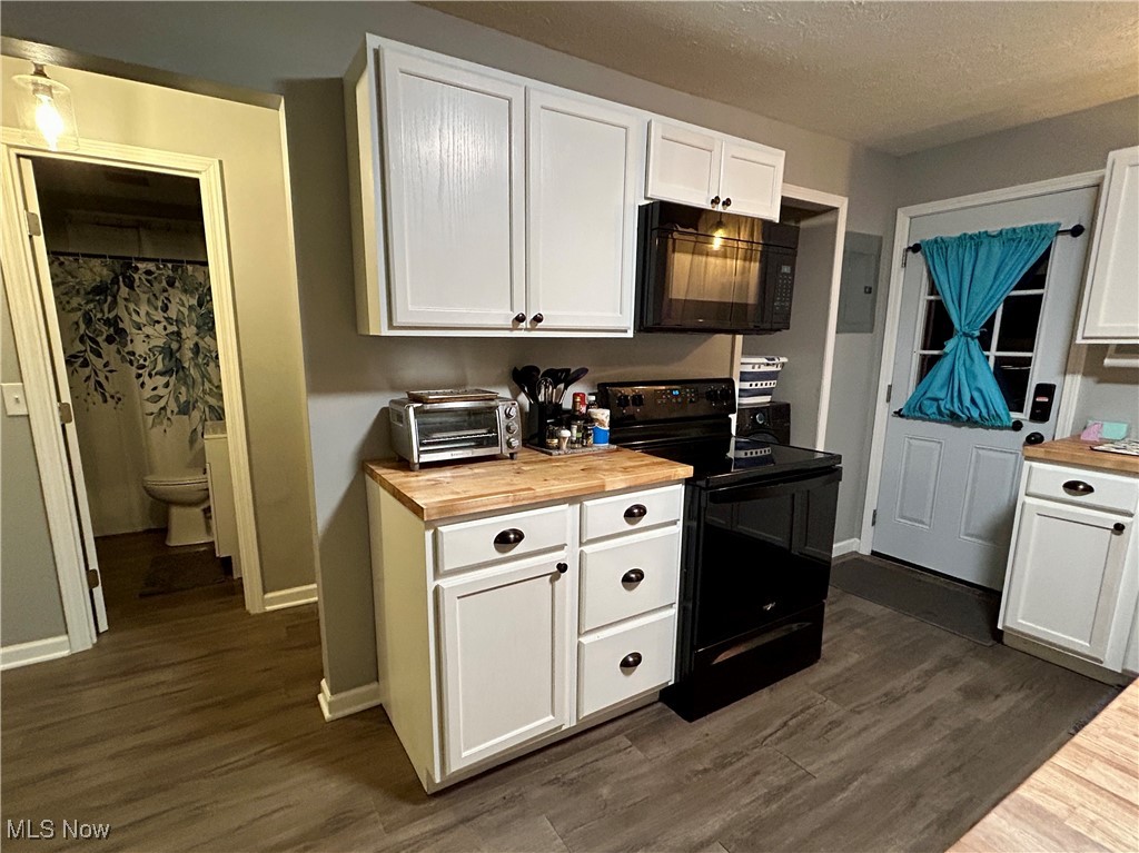 364 Erie Road Vermilion, OH 44089 - Photo 9 of 20 Kitchen featuring white cabinets, butcher block countertops, black appliances, dark wood-style flooring, and a textured ceiling
