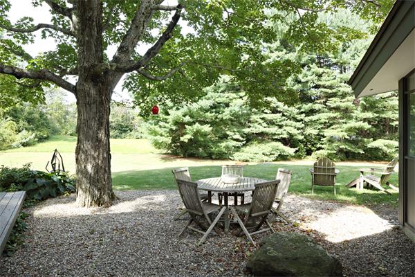 5 Old Conant Road Lincoln, MA 01773 - Photo 11 of 15 a view of a backyard with table and chairs potted plants and large tree