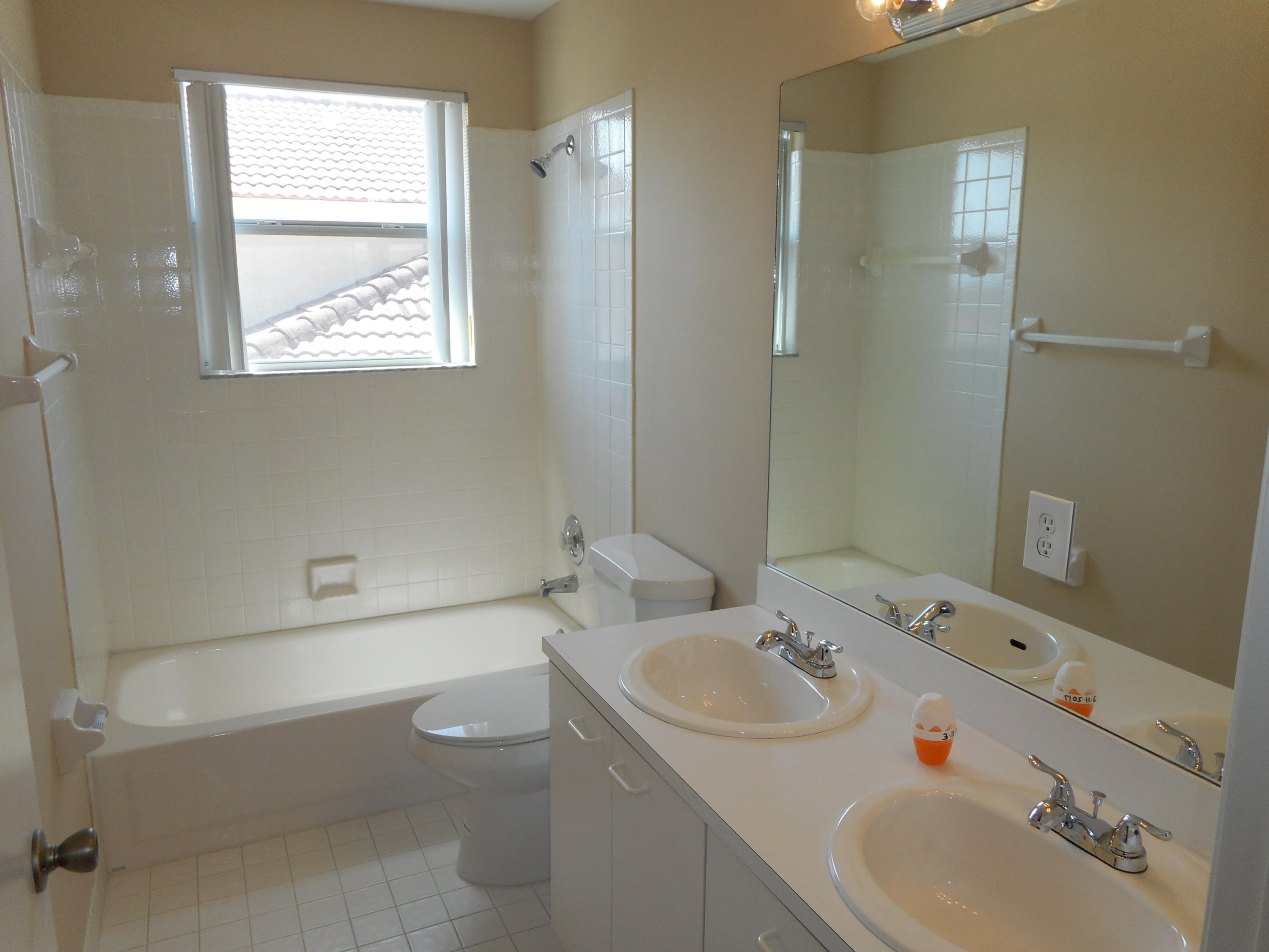 7386 Michigan Isle Road Lake Worth, FL 33467 - Photo 5 of 24 a bathroom with a sink a toilet and shower