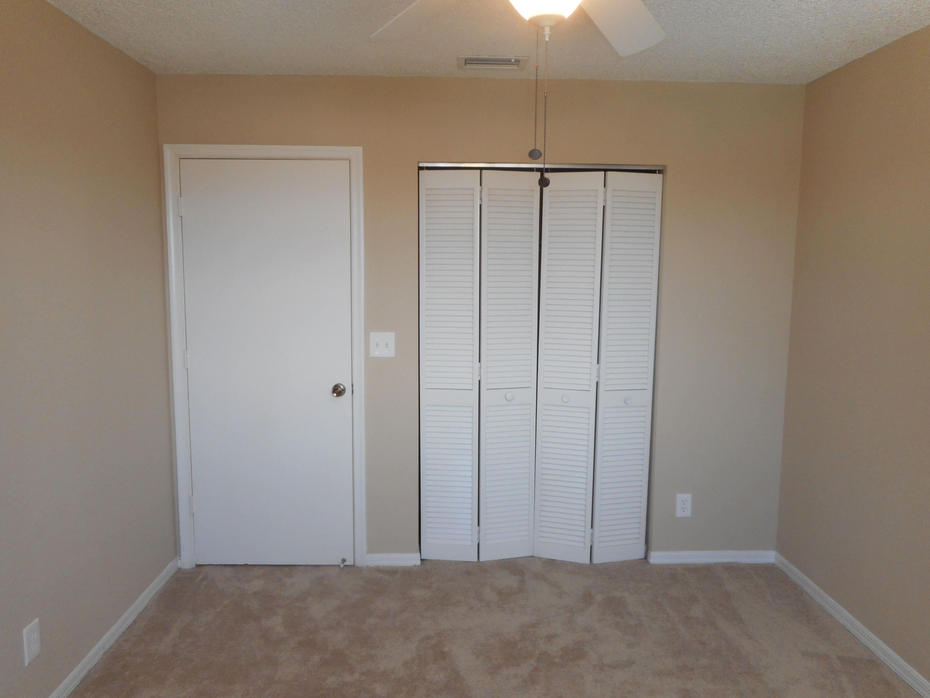 7386 Michigan Isle Road Lake Worth, FL 33467 - Photo 8 of 24 an empty room with closet area