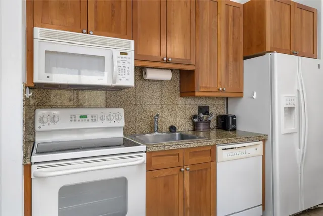 a kitchen with a stove and a refrigerator