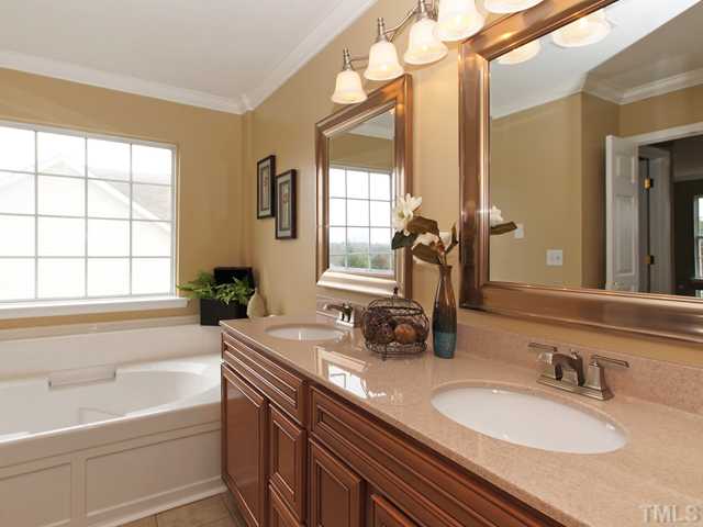 740 Rockville Road Wake Forest, NC 27587 - Photo 15 of 25 a bathroom with a granite countertop sink and a mirror