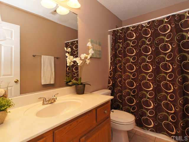 740 Rockville Road Wake Forest, NC 27587 - Photo 17 of 25 a bathroom with a sink and mirror with toilet